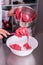 Confectioner mixing pink and white meringue in big bowl