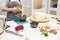 Confectioner prepares a chocolate biscuit cake decorating cream. The concept of homemade pastry, cooking cakes.