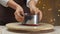 Confectioner removes a metal mold from a red velvet cake