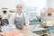 Confectioner woman in her shop selling cookies and cakes