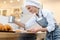 Confectioner woman powdering cocoa on sweet bread