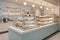Confectionery interior with a neutral palette, natural lighting, and a functional design showcasing a variety of sweets