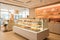 Confectionery interior with a neutral palette, natural lighting, and a functional design showcasing a variety of sweets