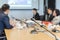 Conference microphones on the table over abstract blurred of attendee in meeting room