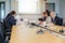 Conference microphones on the table over blurred of attendee in meeting room background