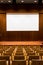 Conference room with wooden seating, stage and large cinema screen in auditorium. Wooden room for conferences and shows, cinema