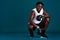 Confidence breeds my strength. Full length portrait of a handsome young boxer crouching against a dark background with