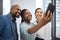 Confidence shines through them all. a group of businesspeople taking selfies together in an office.