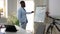 Confident African American business coach talking pointing at whiteboard with success tips looking at laptop video chat