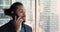 Confident African businessman in suit talk to client on cellphone