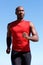 Confident african sports man running outdoors