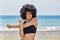 Confident afro american sportswoman training on beach