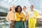 Confident afro female leader with crossed arms standing with partners