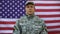 Confident american soldier folding arms on flag background, professionalism