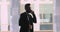 Confident arabic businessman wear suit talking on phone in office