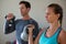 Confident athletes exercising with kettlebells