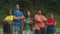 Confident attractive diverse multiracial backpacker with arms crossed posing at campsite