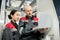 Confident bald mature foreman in workwear holding laptop during presentation