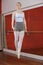 Confident Ballerina In Midair At Dancing Studio
