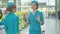 Confident beautiful woman in stewardess uniform talking to colleague in airport, waving goodbye and leaving with travel