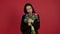 Confident brunette woman holding flowers with smile