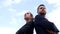 Confident business couple of serious guy and girl stand keeping arms crossed on sky, confidence