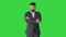 Confident business man with beard and mustashes in suit standing with folded hands on a Green Screen, Chroma Key.