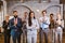 Confident business team standing in office with their hands crossed