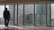 Confident Businessman in a Suit Contemplating Business Deal in His Office, Looking out of the Window. Window Has