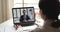 Confident businessman video calling by webcam on laptop screen