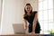 Confident businesswoman posing standing in office smiling looking at camera