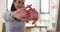 Confident businesswoman sitting at the table and doing arm stretches