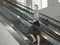 Confident Businesswoman Standing On Escalator