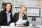 Confident Businesswomen Sitting At Office Desk