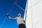 Confident captain of sail boat standing and looking out to sea