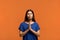 Confident caucasian woman in blue t-shirt practising yoga, holding hands in namaste, praying for peace and love, having calm and