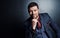 Confident and composed. Cropped portrait of a handsome young businessman sitting with his hand on his chin against a