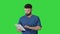 Confident concentrated focused surgeon using digital tablet on a Green Screen, Chroma Key.