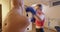 Confident concentrated young woman boxing mannequin in gym. Portrait of strong Caucasian sportswoman working out indoors