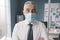 Confident corporate businessman with surgical mask