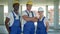 Confident diverse team of workmen and women standing grouped in their dungarees and hardhats smiling at the camera