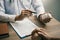 Confident doctor man holding a pill bottle and talking with senior patient and reviewing his medication at office room