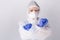 Confident doctor in protective equipment, crossed fists on white background with space. Fighting the virus. Stop covid