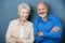 Confident elderly couple with folded arms