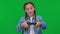 Confident engrossed girl gaming with gamepad joystick on green screen making facial expressions. Portrait of Caucasian
