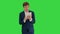 Confident entrepreneur dressed in suit working on digital tablet on a Green Screen, Chroma Key.