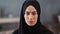 Confident face of young Saudi woman wearing black hijab headscarf. Close up shot on 4k RED camera