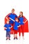 confident family of superheroes in masks and cloaks standing with hands on waist and looking away
