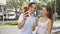 Confident father and daughter share a lovely moment, joyfully taking a cool selfie on their mobile phone standing on a bustling