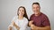 Confident father and daughter sharing a joyful dance, smiling on white isolated background, displaying a happy hispanic family